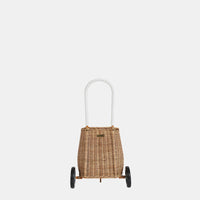 Natural rattan toddler basket with two wheels and a tall white handle, shown against a plain background from Olli Ella Kids Rattan