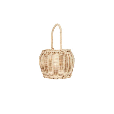 Olli Ella Home straw rattan basket with a rounded woven design and tall loop handle, ideal for carrying toys, Easter eggs, and other treasures