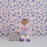 Dinkum Dolls doll dressed in a pastel fairy costume with glittery pink wings, tulle tutu, purple shoes, and a matching floral gift bag